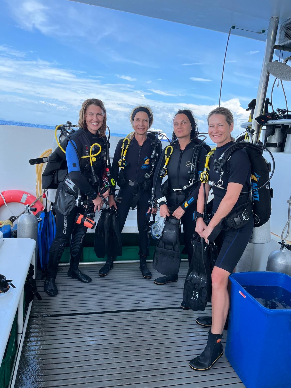 Advanced Open Water Diver students smiling in full scuba gear before a dive in the Similan Islands