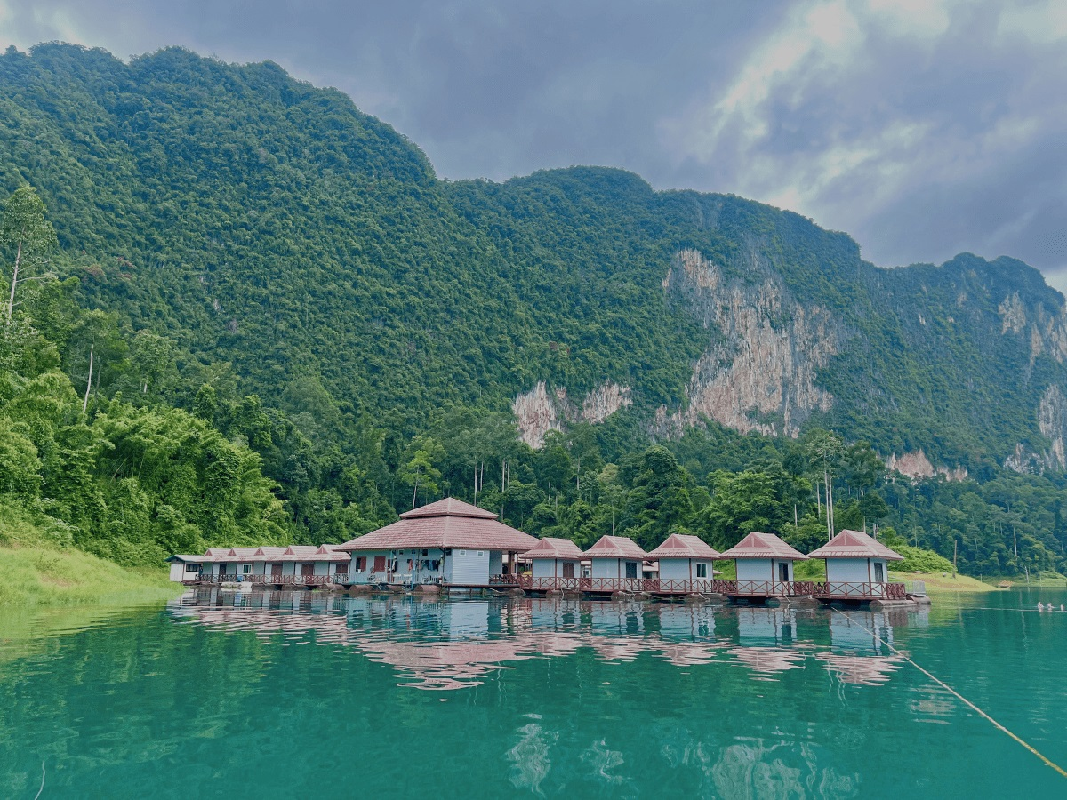 Floating bungalows on Cheow Lan Lake surrounded by rainforest and limestone cliffs in Khao Sok