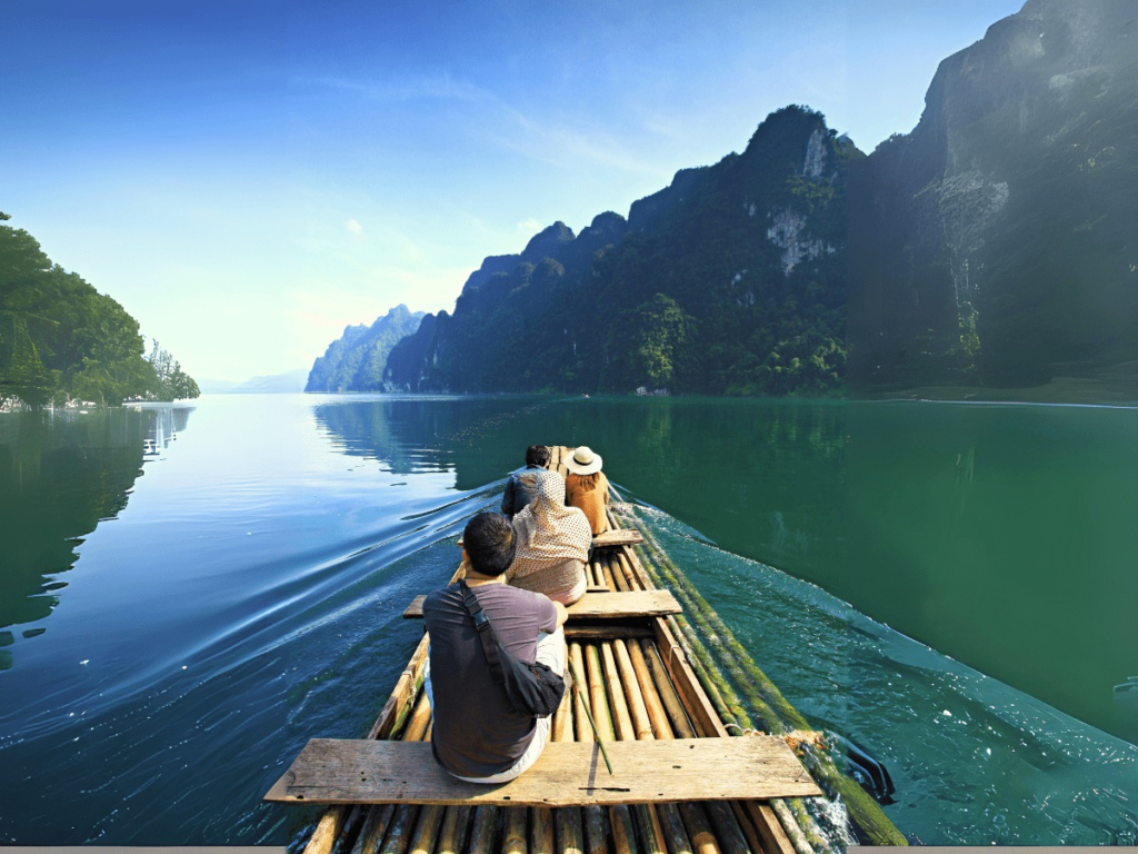 Visitors relaxing on a bamboo raft surrounded by peaceful nature on Cheow Lan Lake, Khao Sok