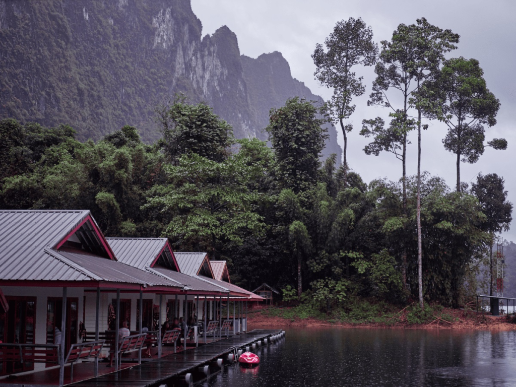 Floating bungalows on Cheow Lan Lake surrounded by forest and limestone cliffs, Thailand
