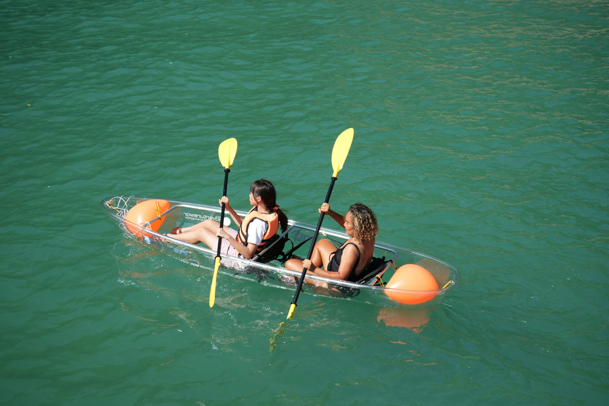 Customers canoeing on calm waters in Phang Nga Bay